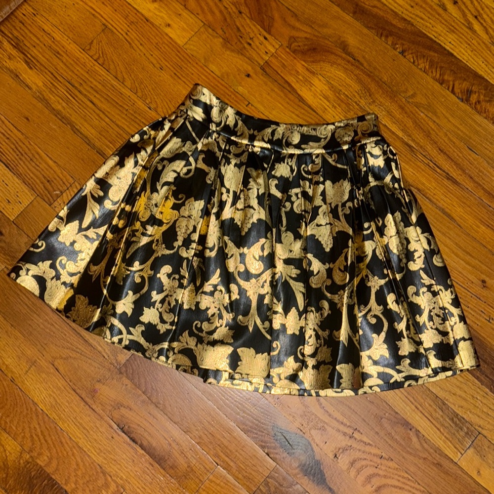 Gold metallic print on black leather skirt Alice + Olivia